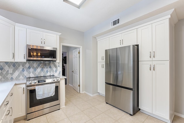 kitchen with visible vents, white cabinets, appliances with stainless steel finishes, and light countertops