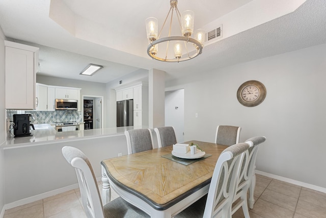 dining area with light tile patterned floors, visible vents, baseboards, and a notable chandelier