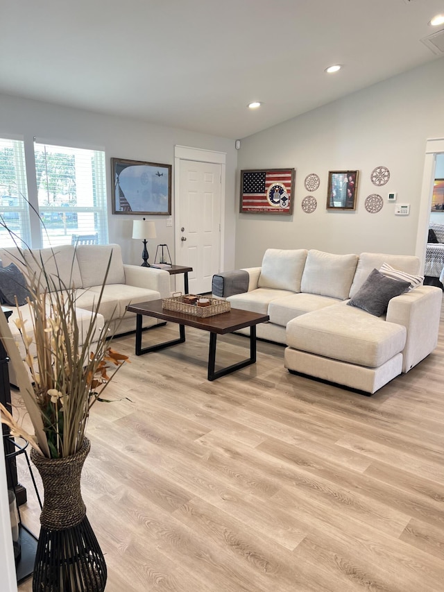 living room featuring light wood-style floors, vaulted ceiling, and recessed lighting