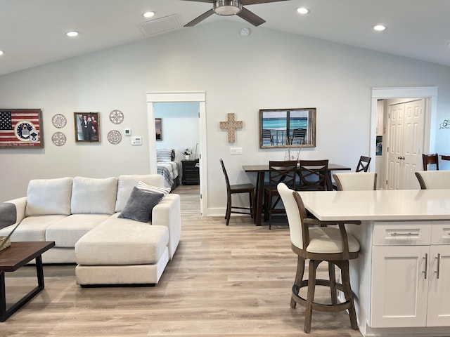 living area with lofted ceiling, light wood finished floors, ceiling fan, and recessed lighting