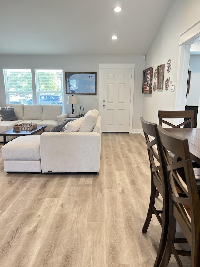 living room with light wood finished floors, baseboards, and recessed lighting