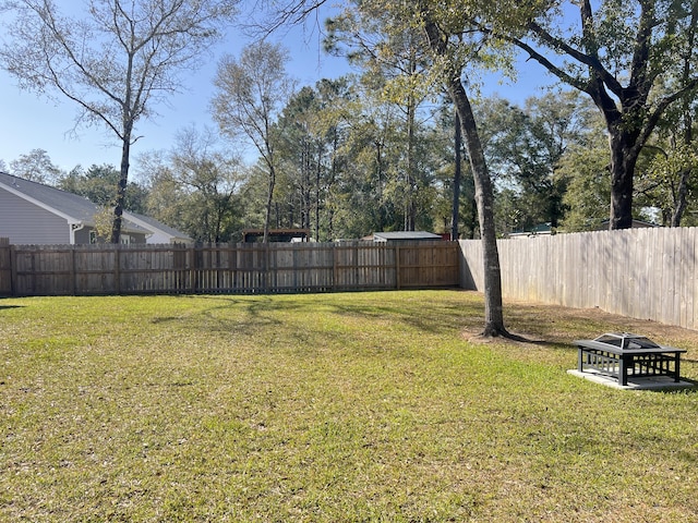 view of yard featuring a fire pit and fence