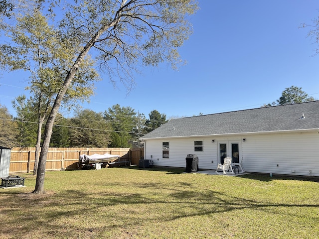 rear view of property with french doors, a lawn, fence, and central air condition unit