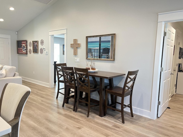 dining space with lofted ceiling, light wood-type flooring, baseboards, and recessed lighting