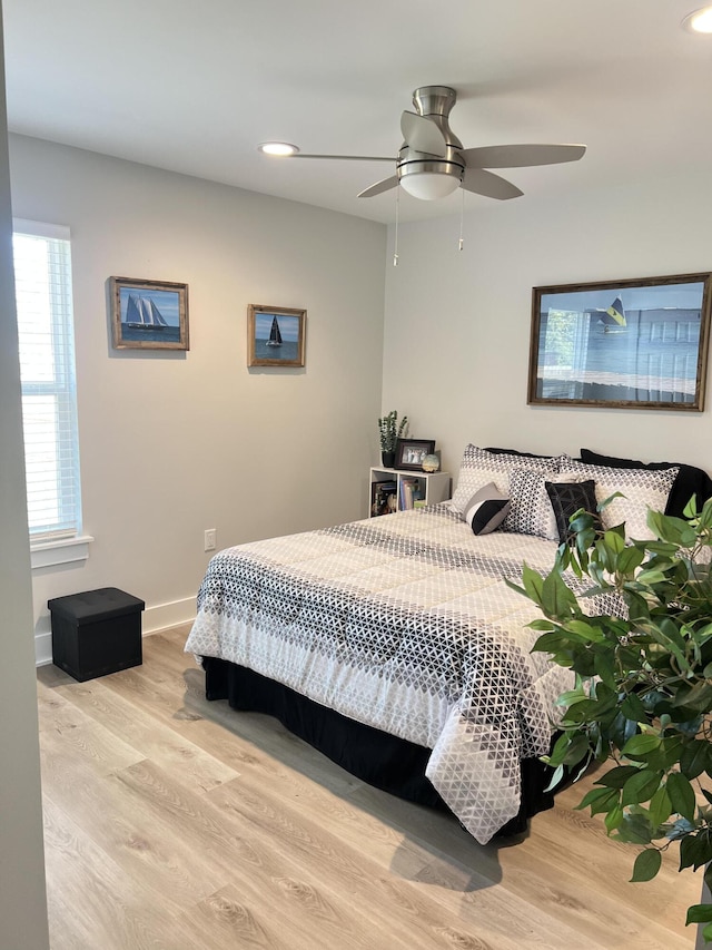 bedroom featuring ceiling fan, recessed lighting, wood finished floors, and baseboards