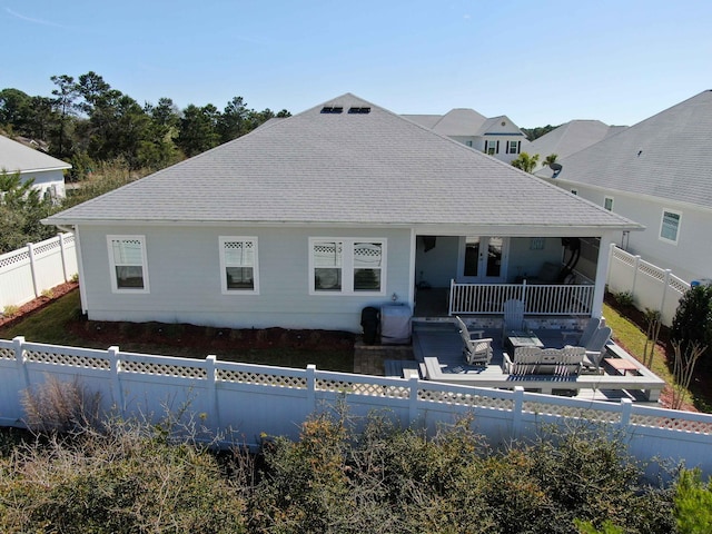 back of property with a patio area, a fenced backyard, and a shingled roof