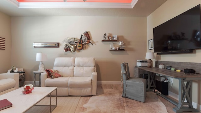 living room featuring crown molding, wood finished floors, and baseboards