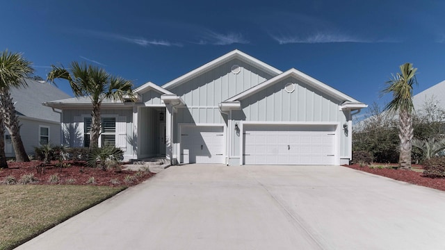 view of front of property with board and batten siding, concrete driveway, and an attached garage