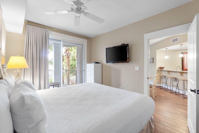 bedroom featuring access to exterior, visible vents, ceiling fan, and wood finished floors