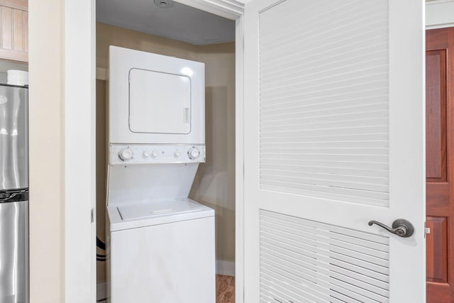 laundry room with stacked washer / dryer and laundry area