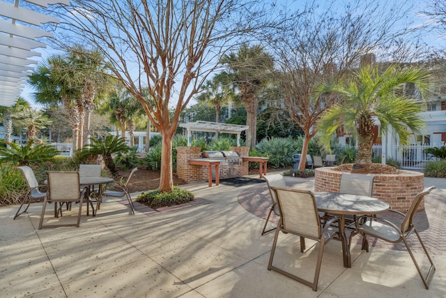 view of patio / terrace with exterior kitchen, outdoor dining area, and a pergola