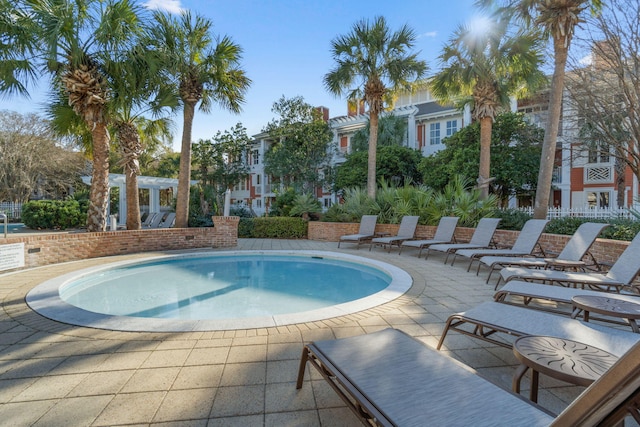 community pool with a patio and a pergola