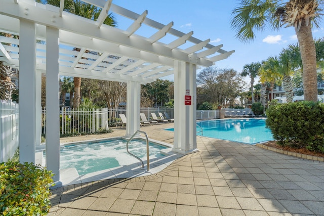 community pool with a patio, a hot tub, a pergola, and fence