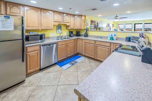 kitchen with light tile patterned floors, stainless steel appliances, recessed lighting, visible vents, and a sink