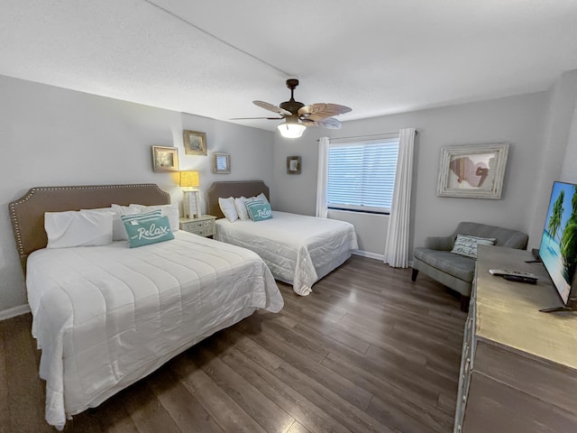 bedroom featuring dark wood-style floors, ceiling fan, and baseboards