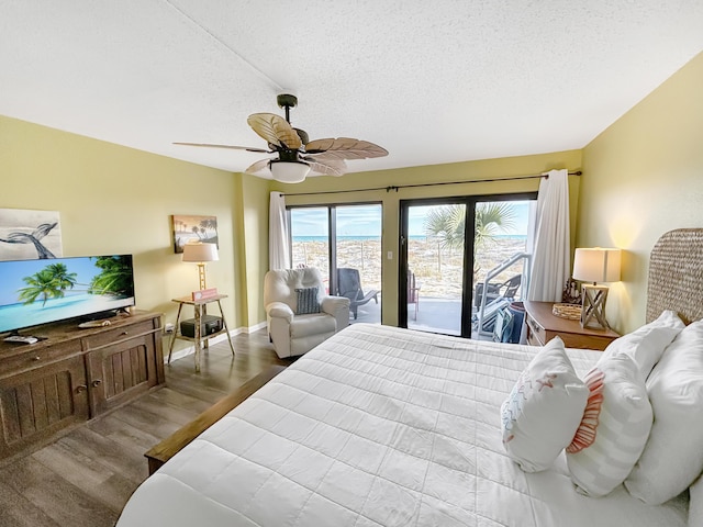 bedroom with baseboards, a ceiling fan, wood finished floors, access to outside, and a textured ceiling