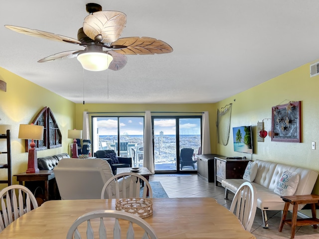 dining room featuring light tile patterned floors, visible vents, and a ceiling fan