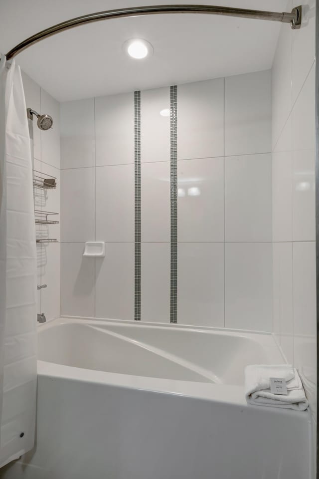 bathroom with shower / bathtub combination with curtain