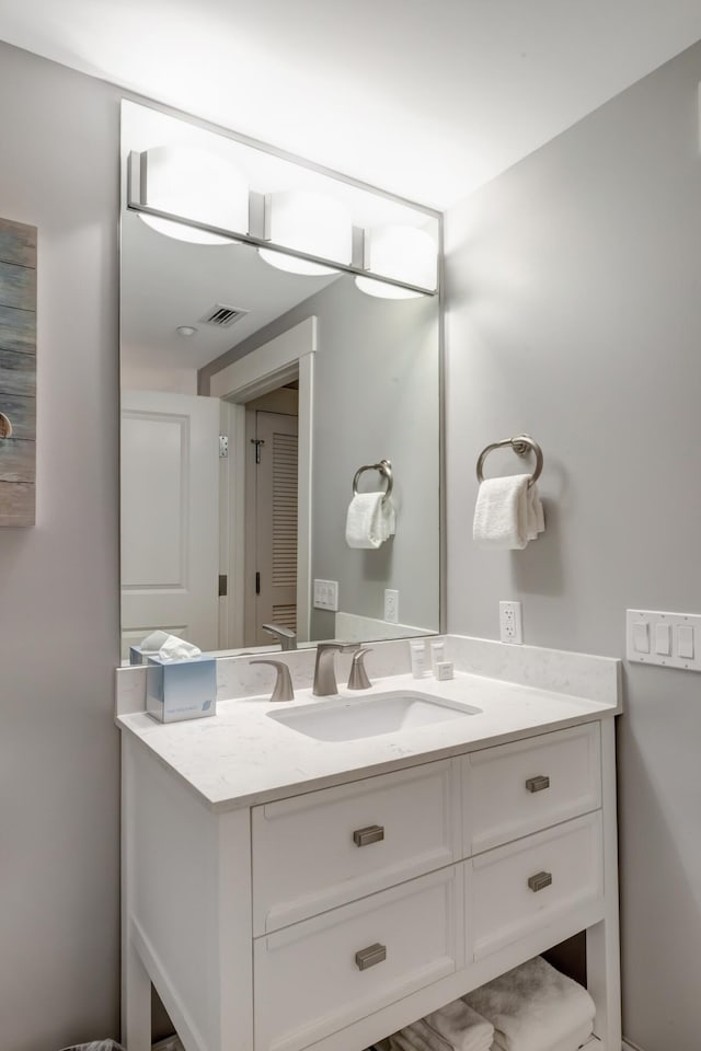 bathroom featuring vanity and visible vents