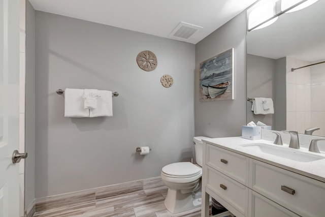 full bathroom with visible vents, baseboards, toilet, vanity, and a shower