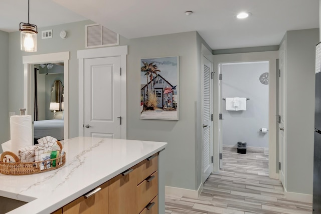 bathroom with visible vents, baseboards, recessed lighting, wood finished floors, and vanity