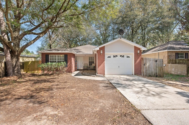 single story home with an attached garage, fence, concrete driveway, and brick siding