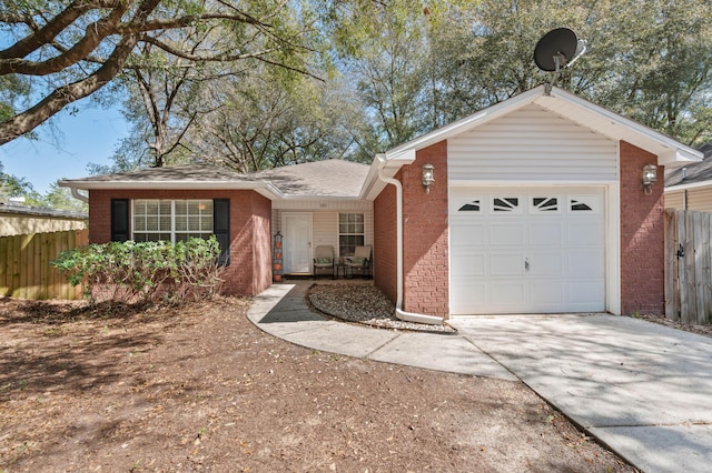 single story home with a garage, brick siding, fence, and driveway