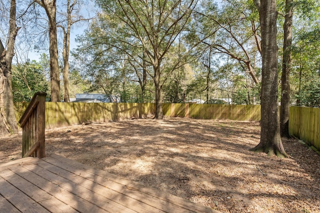 view of yard featuring a fenced backyard and a wooden deck