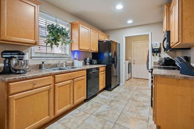 kitchen featuring light tile patterned flooring, recessed lighting, a sink, black appliances, and washer / clothes dryer