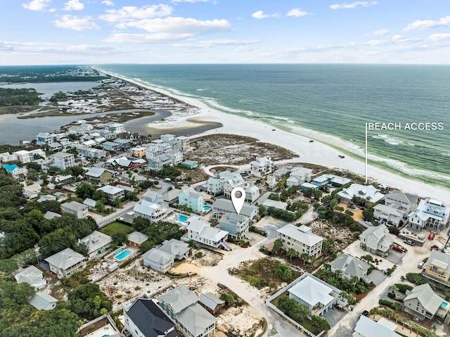 birds eye view of property featuring a water view and a view of the beach