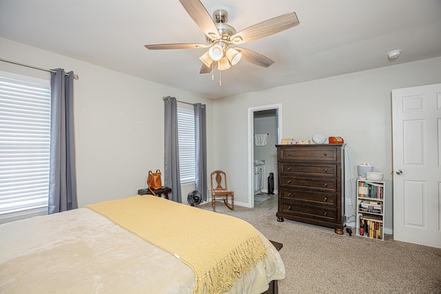 bedroom featuring multiple windows, light colored carpet, baseboards, and ceiling fan