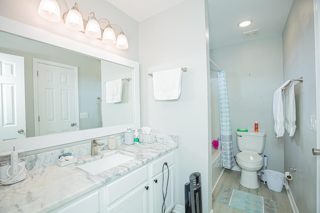 full bath with vanity, wood finished floors, visible vents, shower / tub combo, and toilet