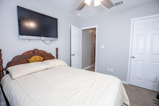 carpeted bedroom with baseboards, visible vents, and ceiling fan