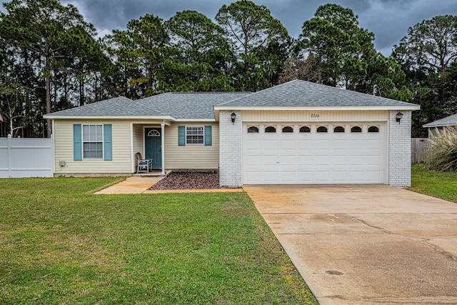 ranch-style home featuring driveway, fence, a front yard, an attached garage, and brick siding