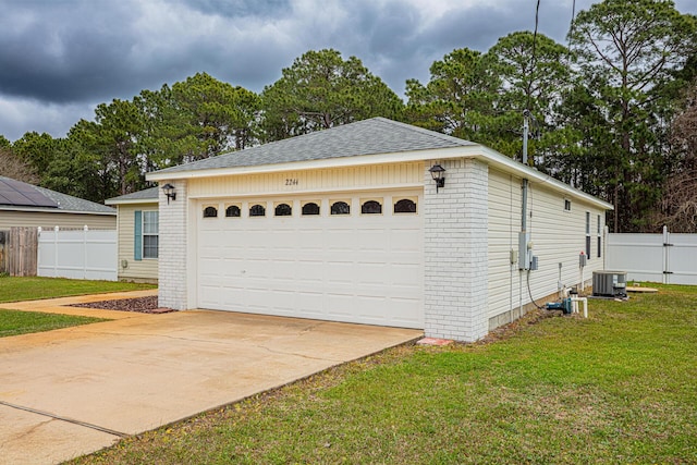 garage with cooling unit, concrete driveway, and fence