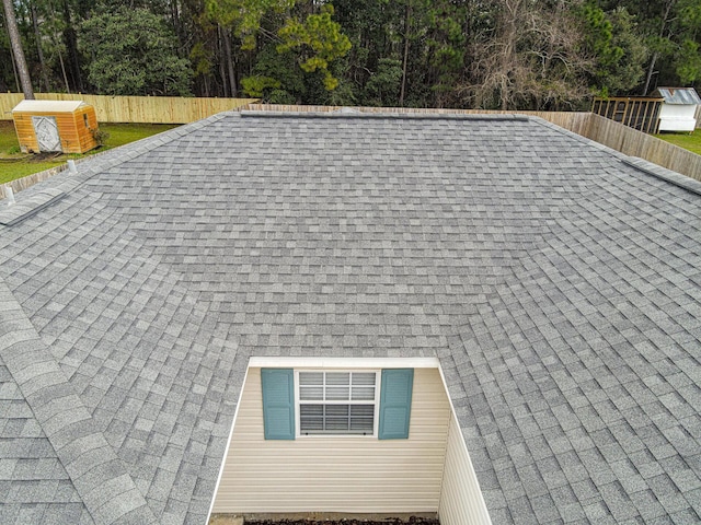 details with roof with shingles and fence