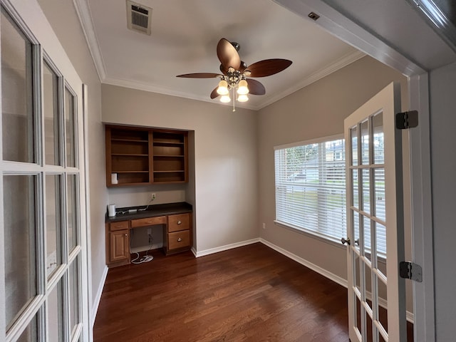 unfurnished office featuring dark wood-style floors, visible vents, crown molding, and built in study area