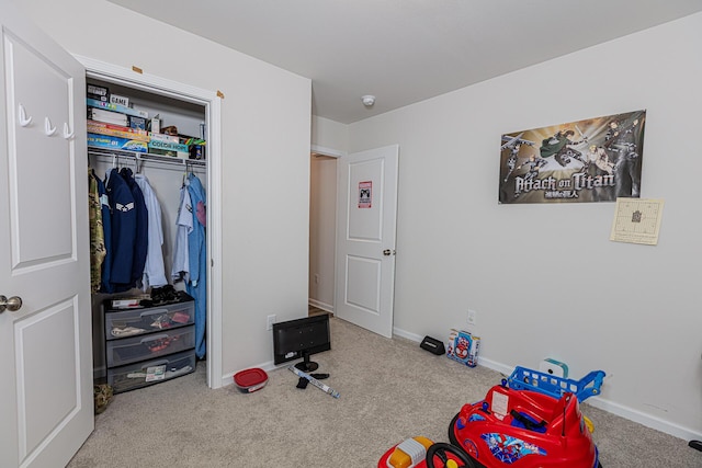 recreation room with carpet floors and baseboards
