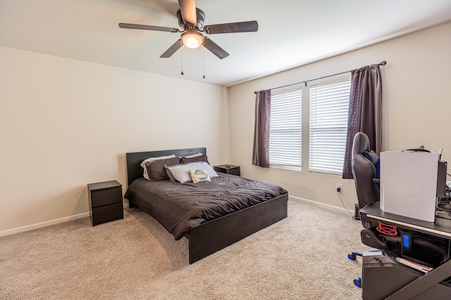 bedroom with a ceiling fan, carpet, and baseboards