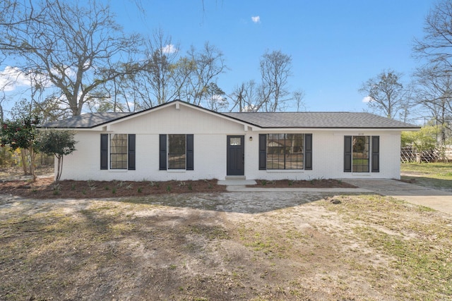 single story home featuring brick siding