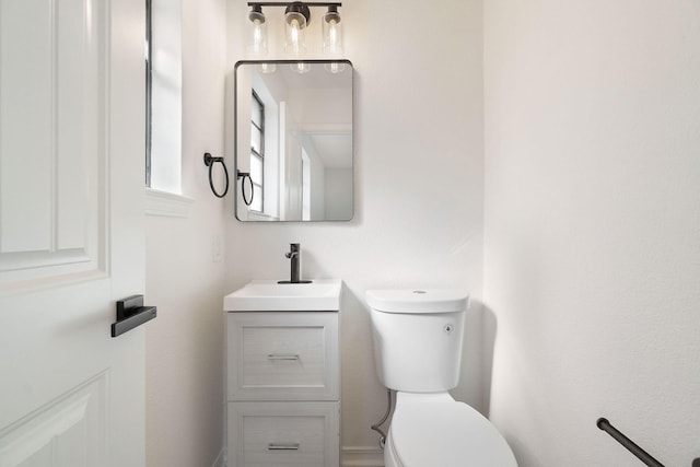 half bathroom with toilet and vanity