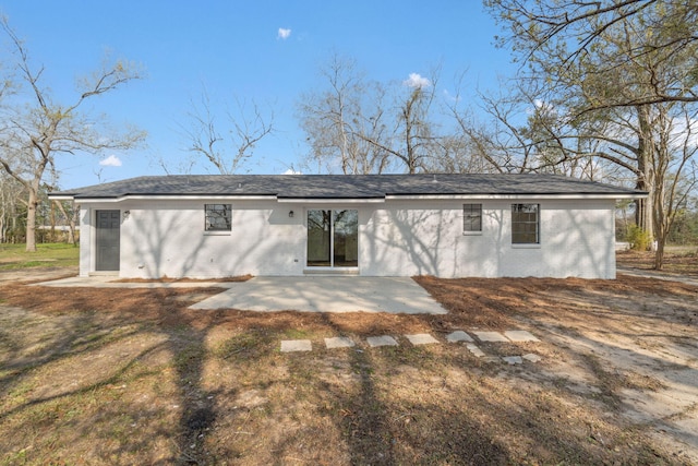 back of property featuring a patio and brick siding