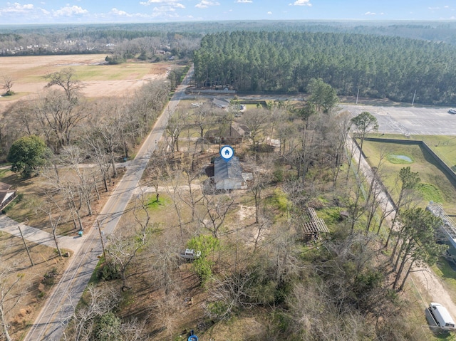 aerial view featuring a rural view and a wooded view