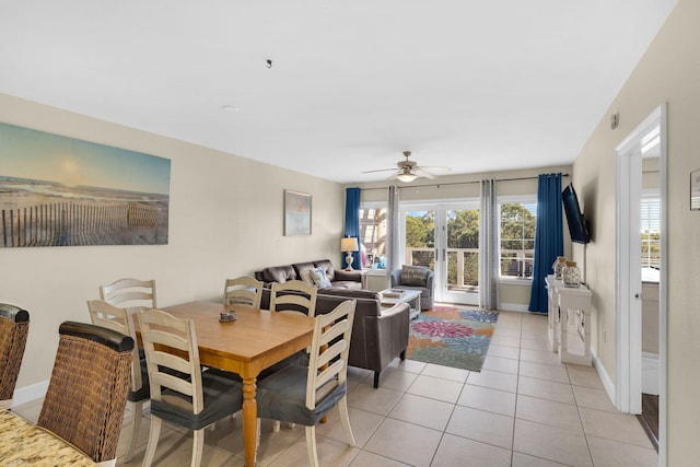 dining space featuring a ceiling fan, light tile patterned flooring, and baseboards