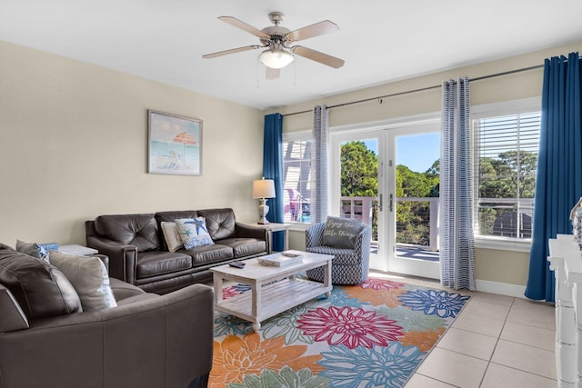 tiled living room with ceiling fan and baseboards