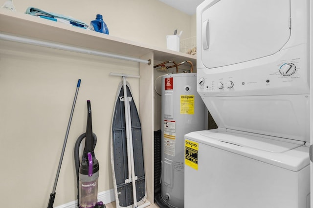 clothes washing area with water heater, laundry area, and stacked washing maching and dryer