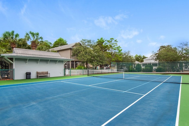 view of tennis court featuring fence