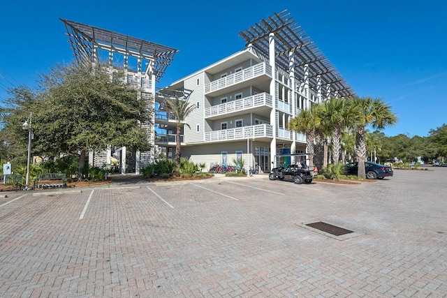 view of building exterior with uncovered parking