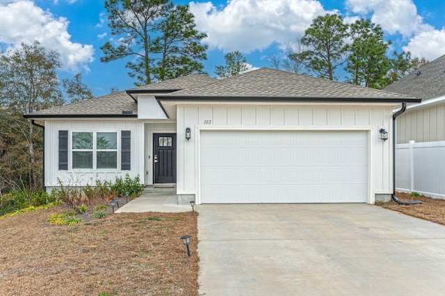 single story home with a shingled roof, board and batten siding, fence, a garage, and driveway