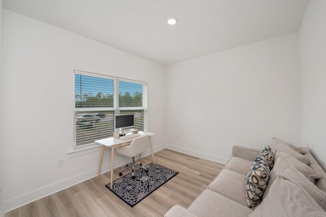 office space featuring baseboards and wood finished floors